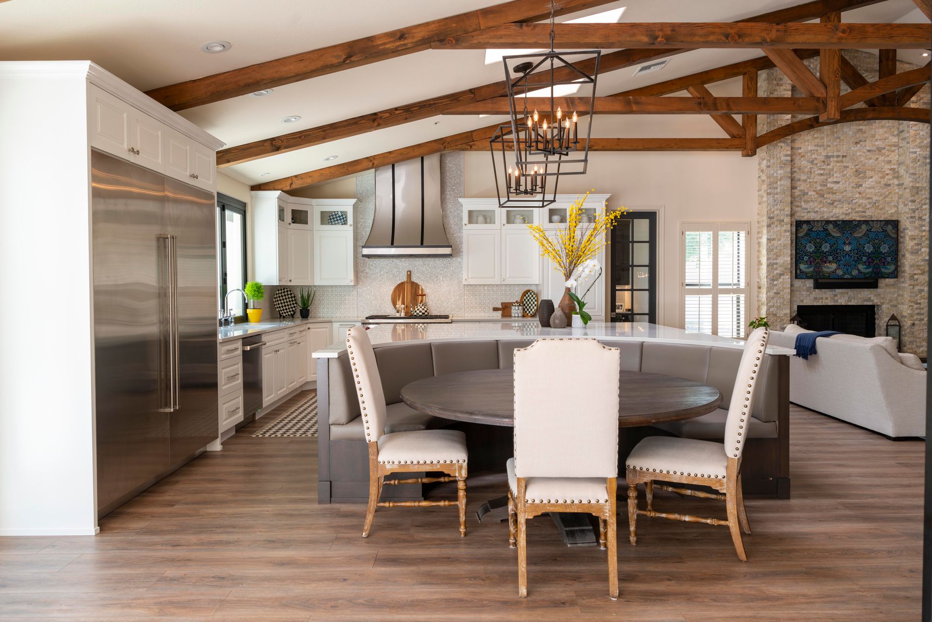 Spacious rustic kitchen with round dining table and modern appliances in Carlsbad, CA