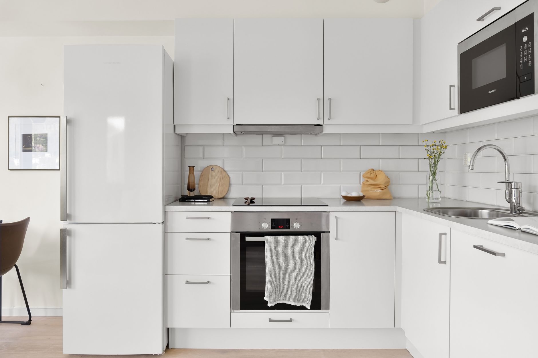 Sleek modern white kitchen featuring stylish appliances and minimalist design. in Carlsbad, CA